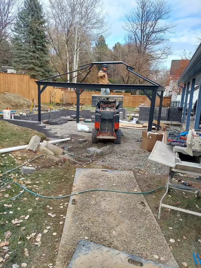 A new courtyard patio with pergola and waterfall highlights this backyard renovation. An existing and cracked concrete pad was replaced with a new paver patio surrounded by seat walls and a 4’ high waterfall along the back.