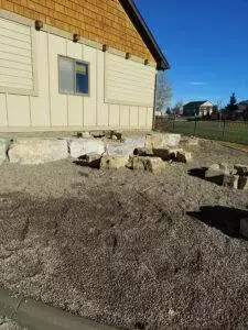 CW Designs removed an existing concrete block retaining wall and garden beds and installed a new square boulder wall that matched the existing landscape.