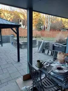 n existing and cracked concrete pad was replaced with a new paver patio surrounded by seat walls and a 4’ high waterfall along the back.